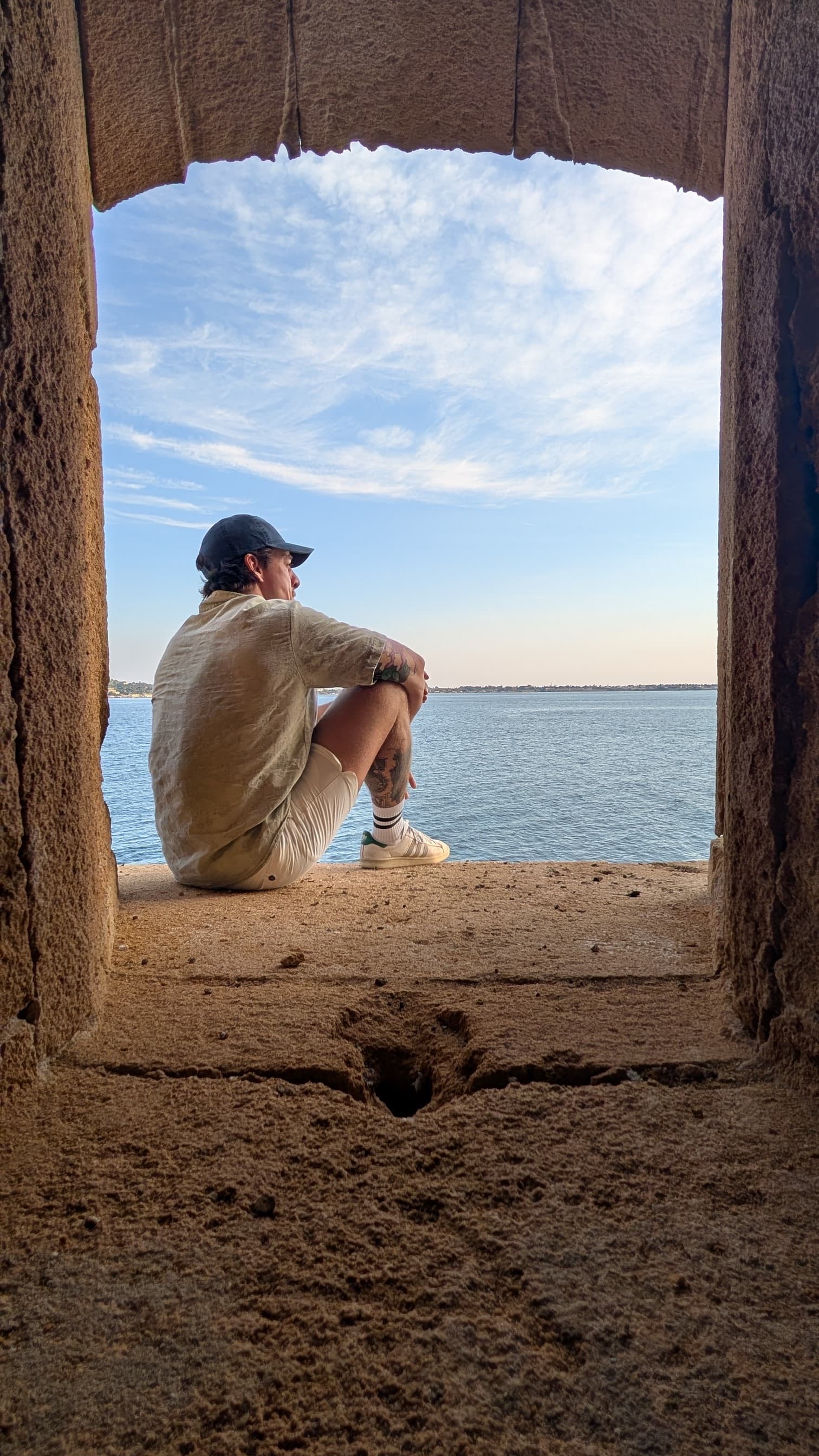 Me sitting on the outside of the castle at Ortigia